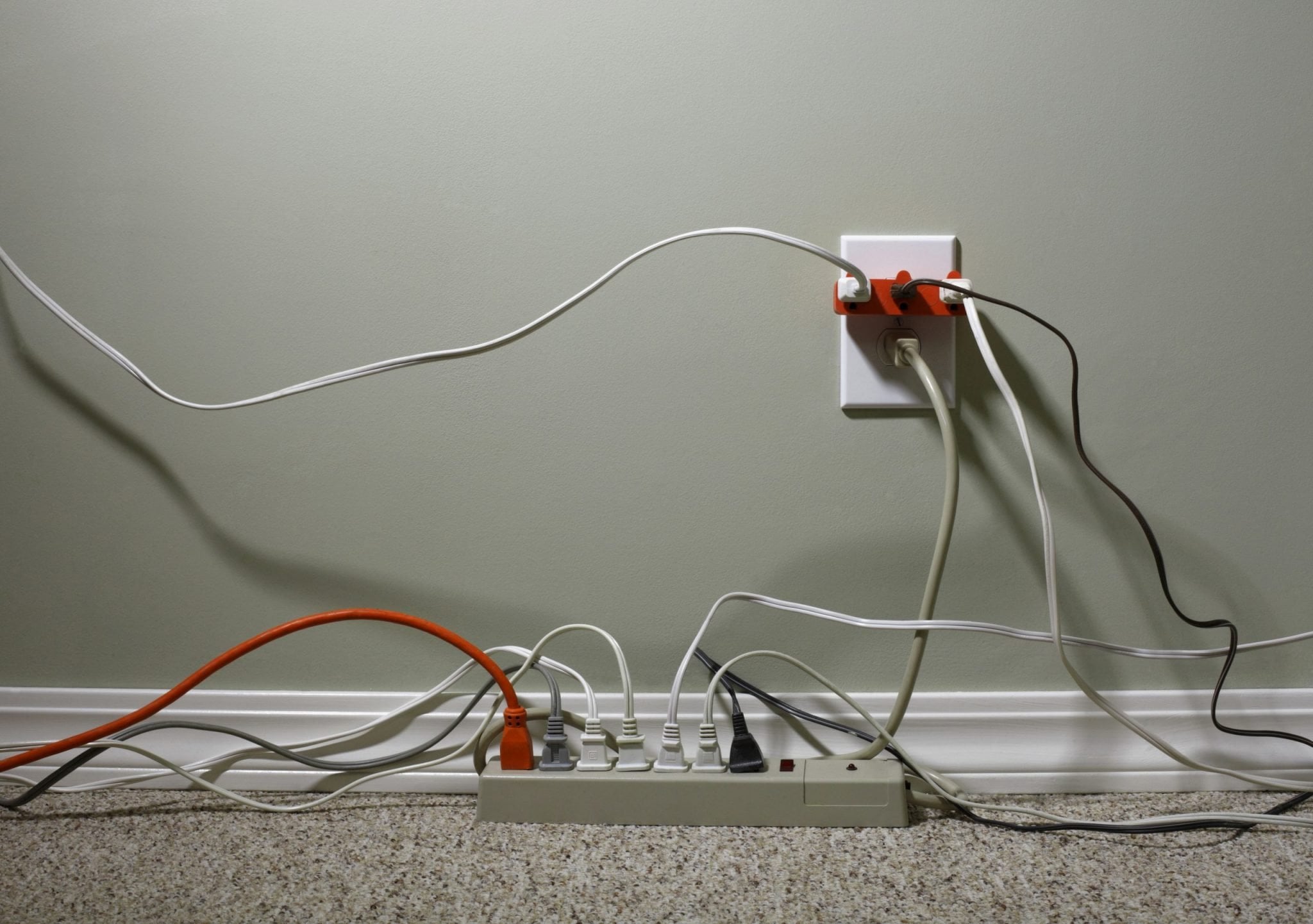 Outlet and surge protector with cords and plugs in every slot.