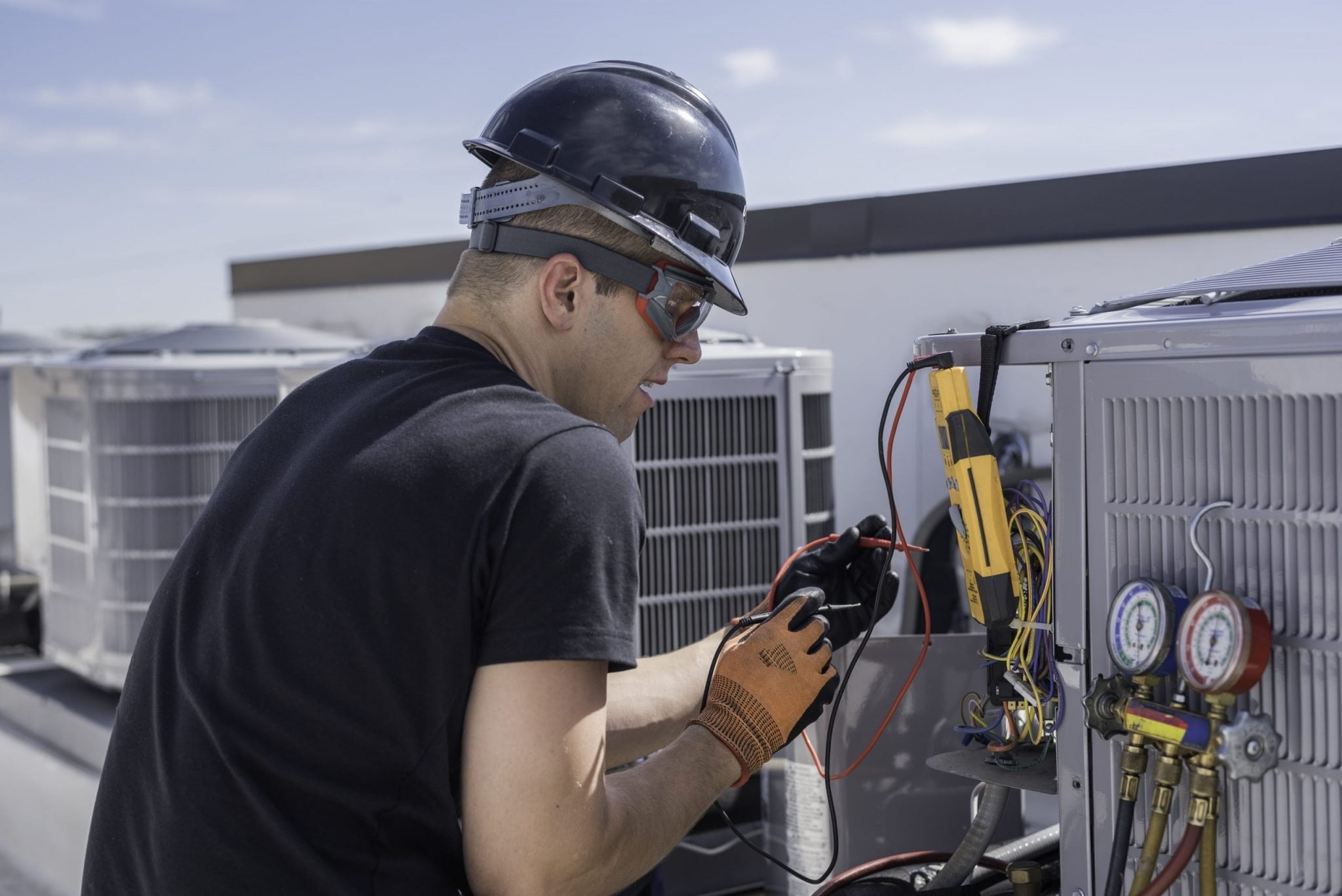 Hvac repair man working with tools on condenser