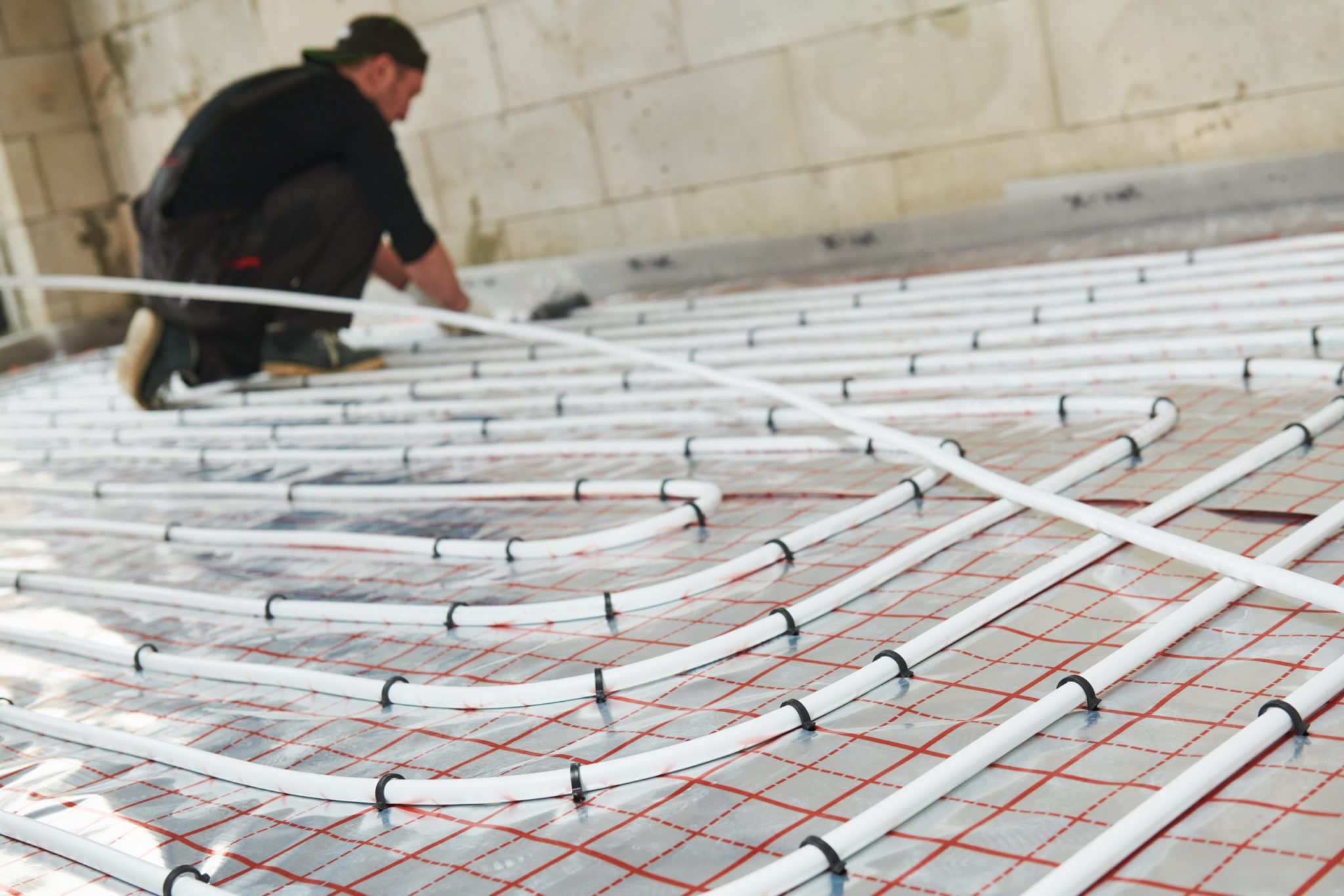 Man installing floor heating system.