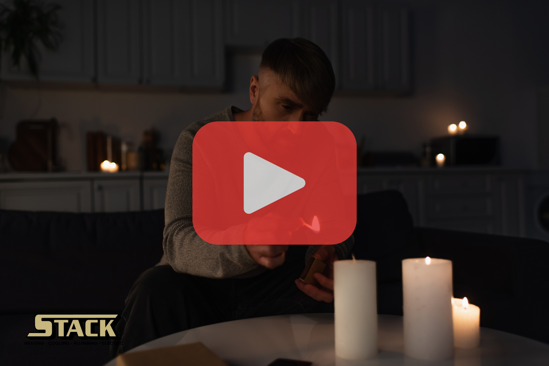 Man lights a candle in a dark kitchen, representing a power outage (STACK logo and play button shown).