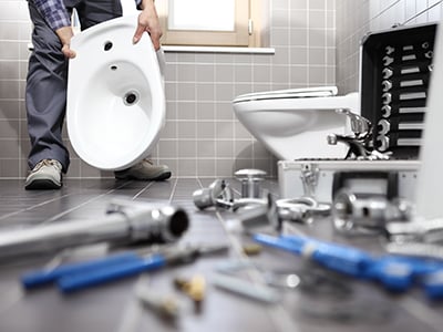 Plumber repairing bathroom toilet