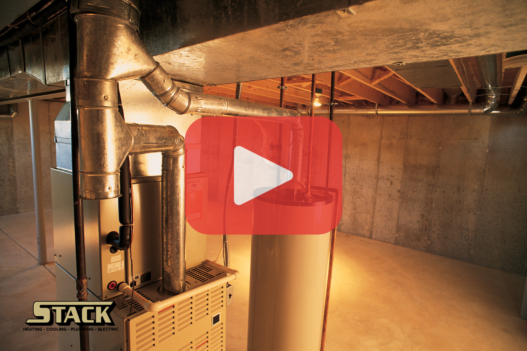 A furnace and water heater installed in a basement with metal venting and piping.