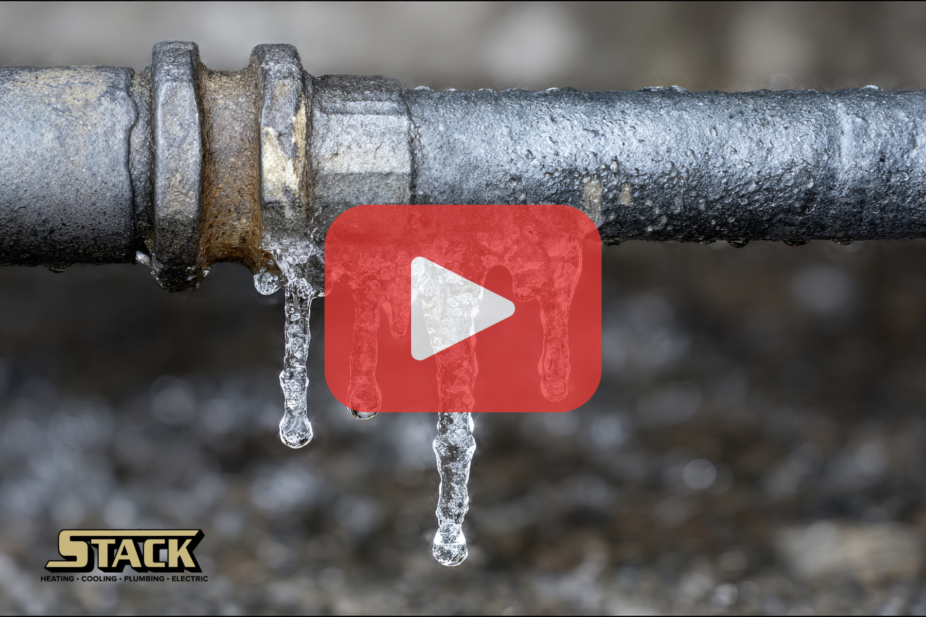 A frozen outdoor pipe with icicles hanging from it, showing the effects of extreme cold and potential plumbing hazards.