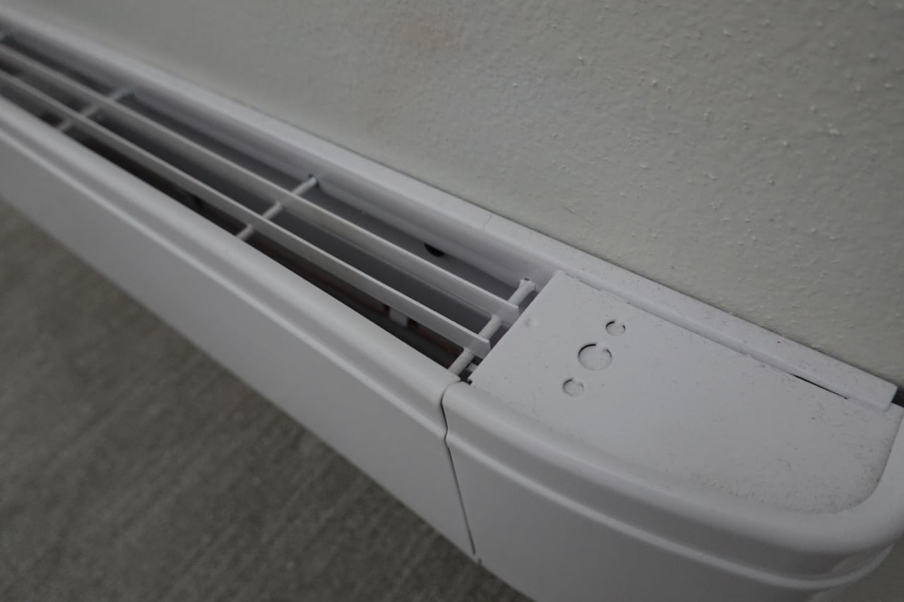 Baseboard Heater Closeup a white electric baseboard heater.