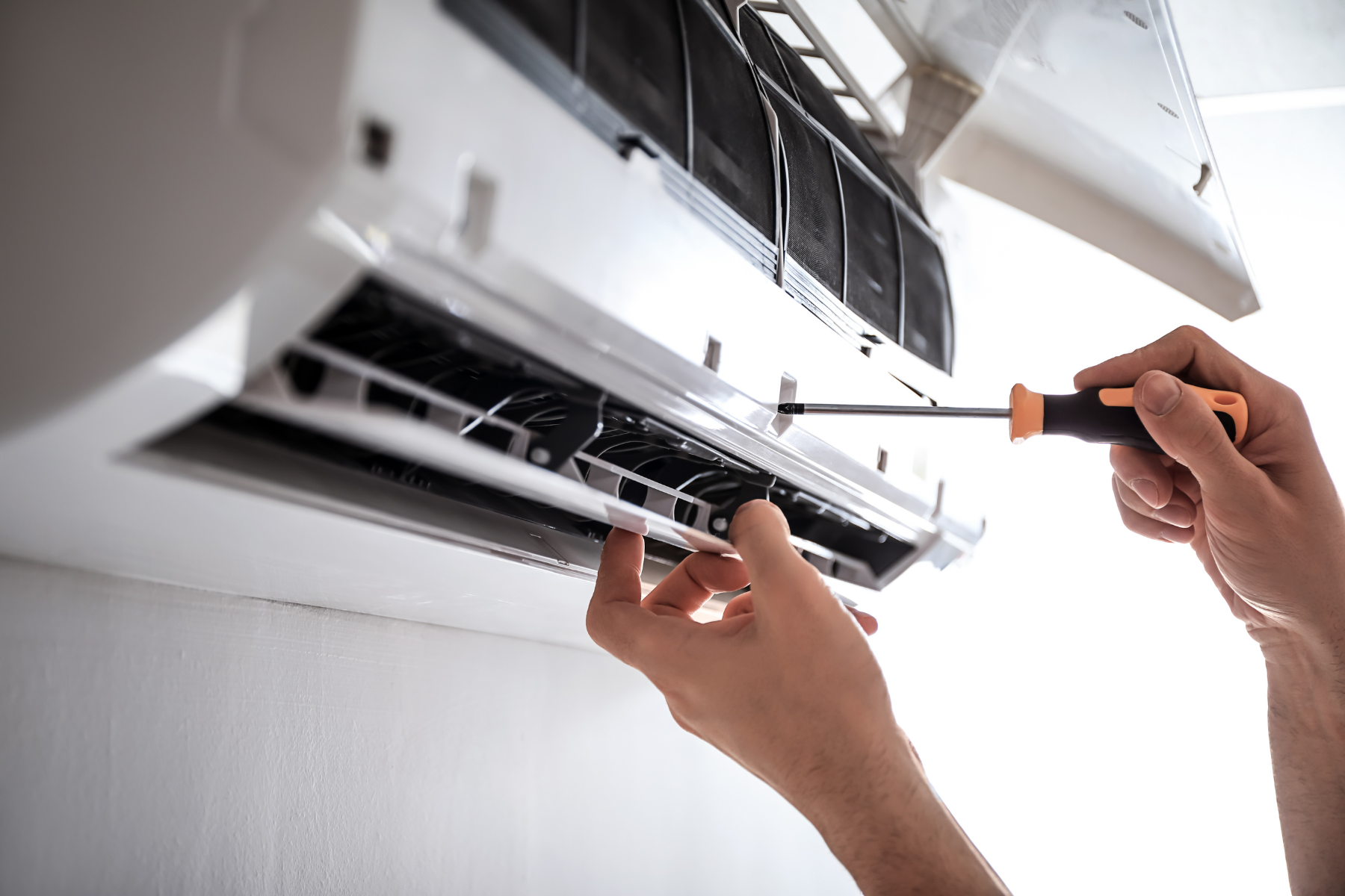Fixing AC with screwdriver.