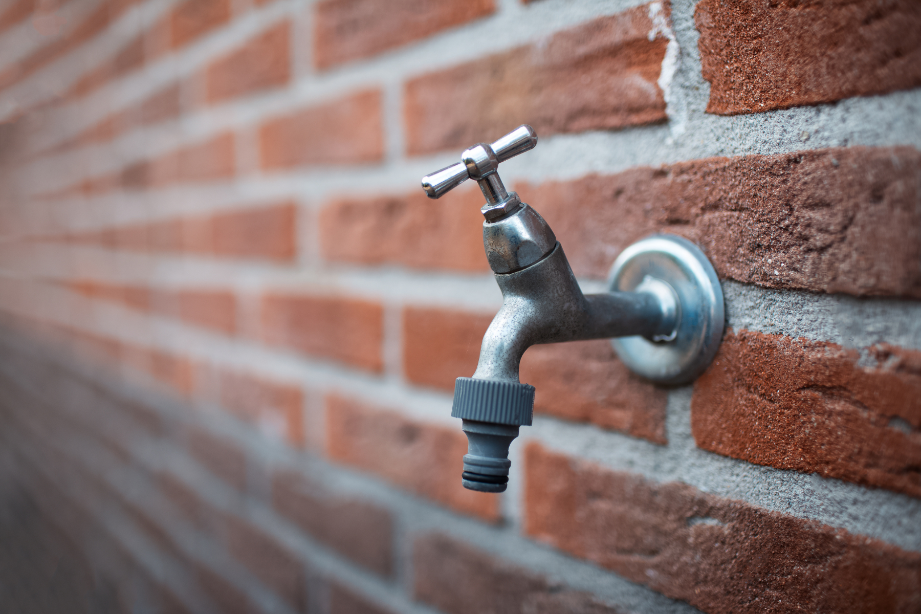 Outdoor spigot on wall.