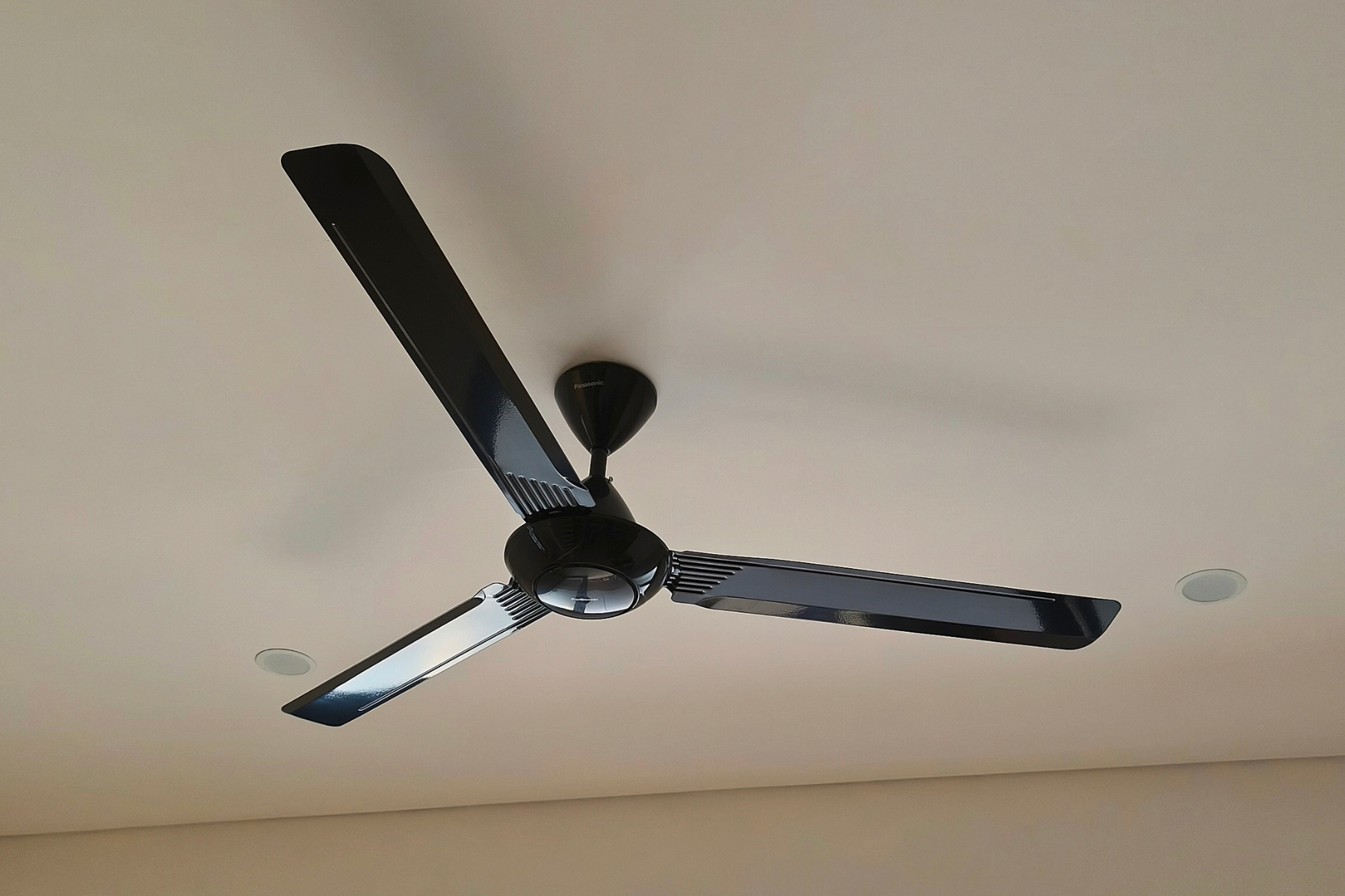Close up of black ceiling fan.
