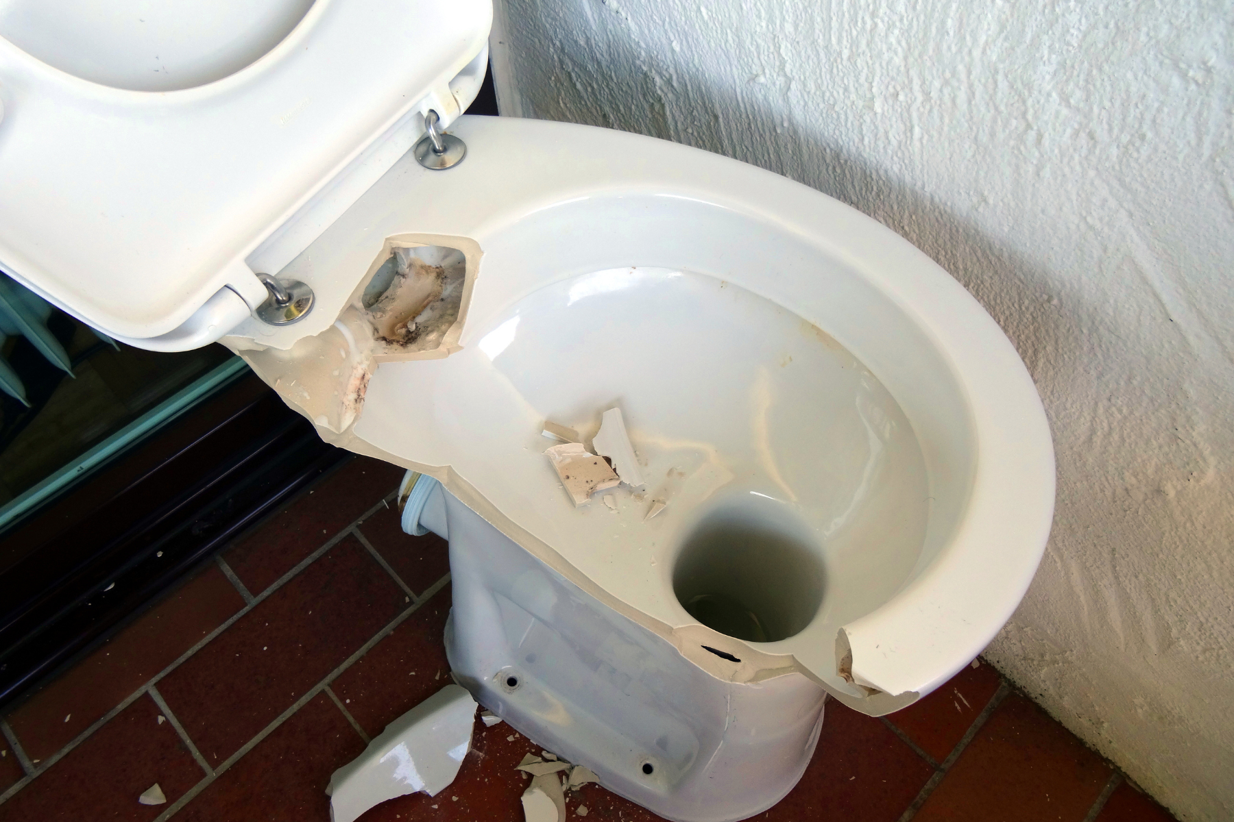 View of broken porcelain toilet seat.