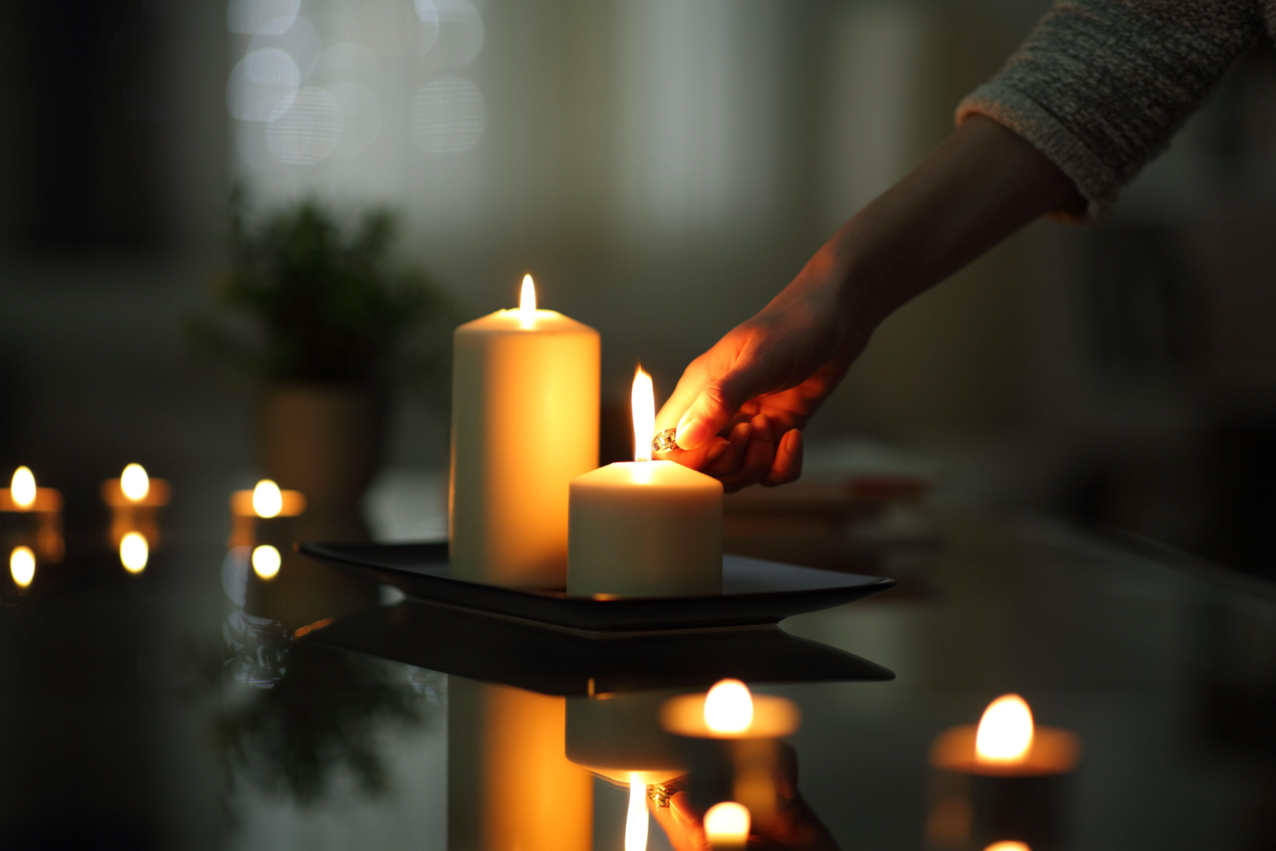 Person lighting candles while there is a power outage.