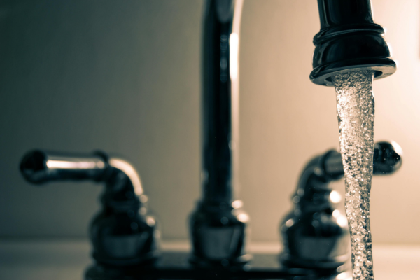 Close up of sink with water running.