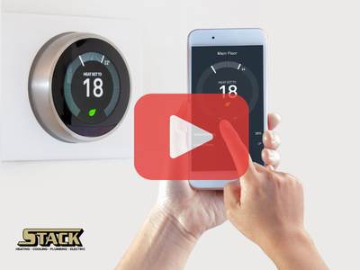 Person using smart thermostate from phone.