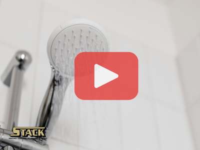 Close up of shower head. Red play buttom and Stack logo.