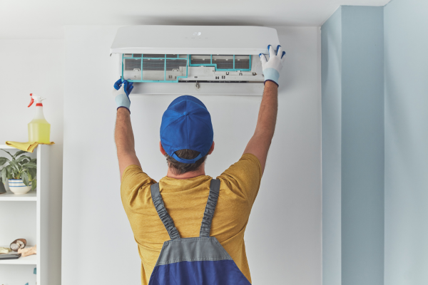 Man taking out AC filter.