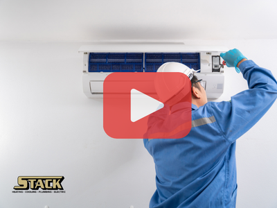 Man fixing AC. Red play buttom overlay and Stack logo.