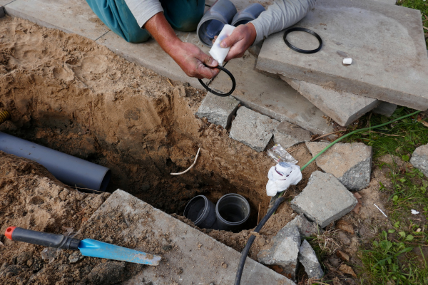 Person fixing sewer line.