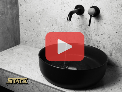 Bathroom sink with red play buttom overlay ans Stack logo,