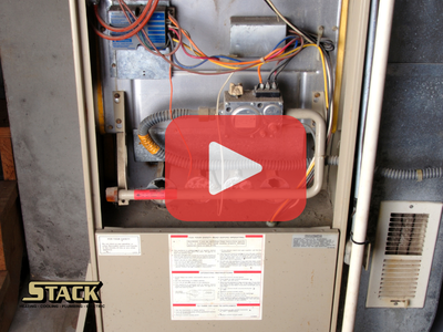 Close up of furnace. Red play buttom overlay and Stack logo.