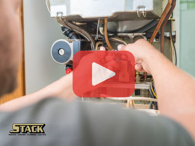 Person fixing furnace in home, red play buttom overlay and Stack logo.
